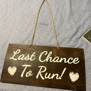 Brown Wooden Sign with White Text